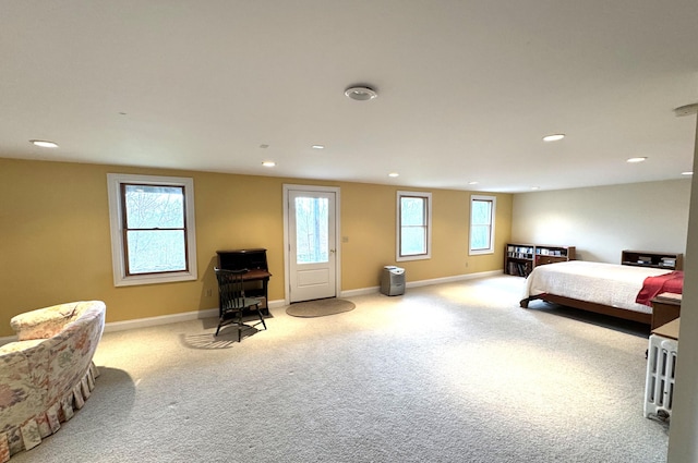 carpeted bedroom featuring baseboards and recessed lighting