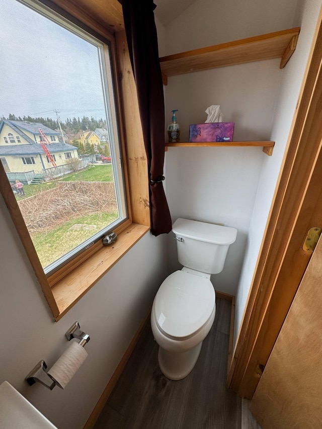 10 Wharf St, Jonesport, ME 04649 - bathroom featuring toilet, baseboards, and wood finished floors