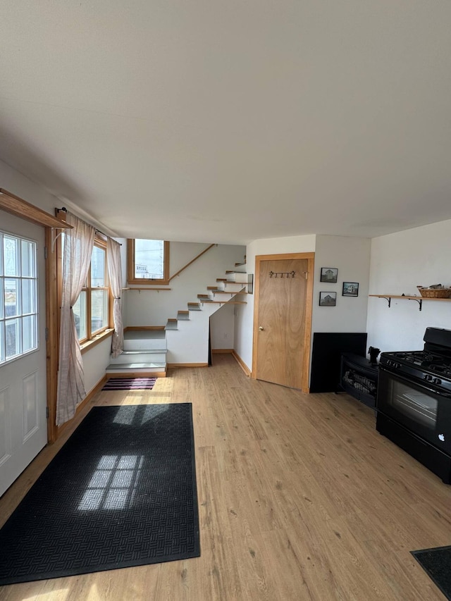10 Wharf St, Jonesport, ME 04649 - unfurnished living room with stairs and light wood-style flooring
