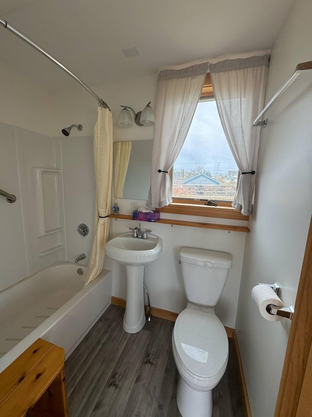 10 Wharf St, Jonesport, ME 04649 - bathroom featuring toilet, baseboards, shower / bathtub combination with curtain, and wood finished floors