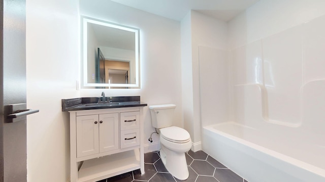 bathroom featuring vanity, tile patterned flooring, and toilet
