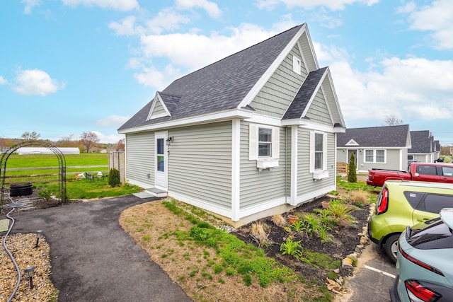 view of home's exterior with roof with shingles
