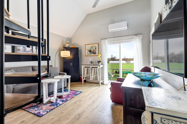 interior space featuring vaulted ceiling, a wall mounted AC, and wood finished floors
