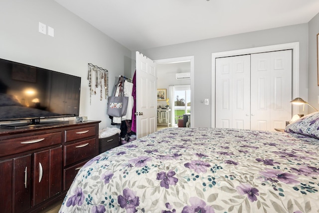 bedroom with a closet and a wall unit AC