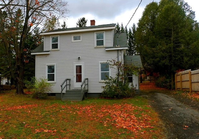 26 Hammond St, Caribou, ME 04736 - view of front of home featuring aphalt driveway, fence, a front yard, and a chimney
