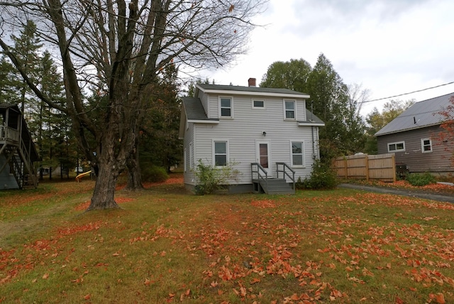26 Hammond St, Caribou, ME 04736 - rear view of property with a yard, fence, and a chimney