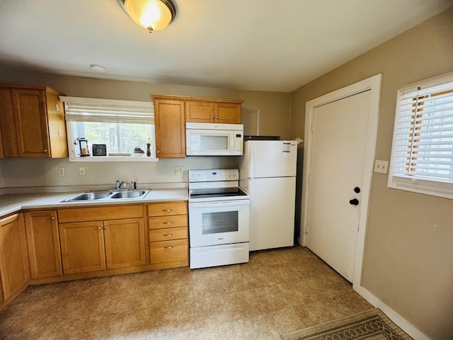 26 Hammond St, Caribou, ME 04736 - kitchen featuring brown cabinets, a sink, white appliances, light countertops, and light floors
