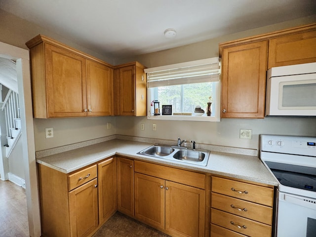 26 Hammond St, Caribou, ME 04736 - kitchen with white appliances, brown cabinetry, a sink, and light countertops