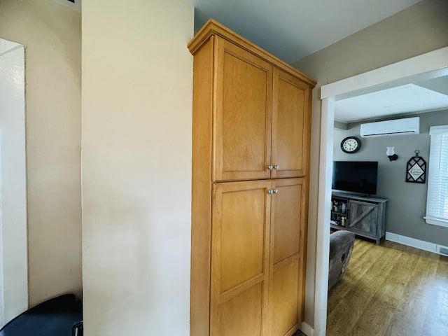 26 Hammond St, Caribou, ME 04736 - interior space featuring visible vents, baseboards, a wall mounted AC, and light wood finished floors