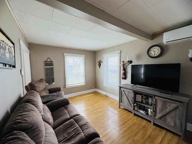 26 Hammond St, Caribou, ME 04736 - living area with wood finished floors, baseboards, and a wall unit AC