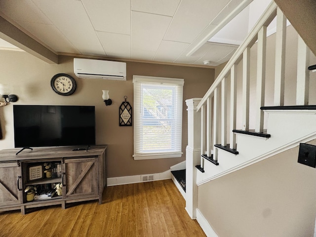 26 Hammond St, Caribou, ME 04736 - staircase featuring baseboards, an AC wall unit, wood finished floors, and visible vents