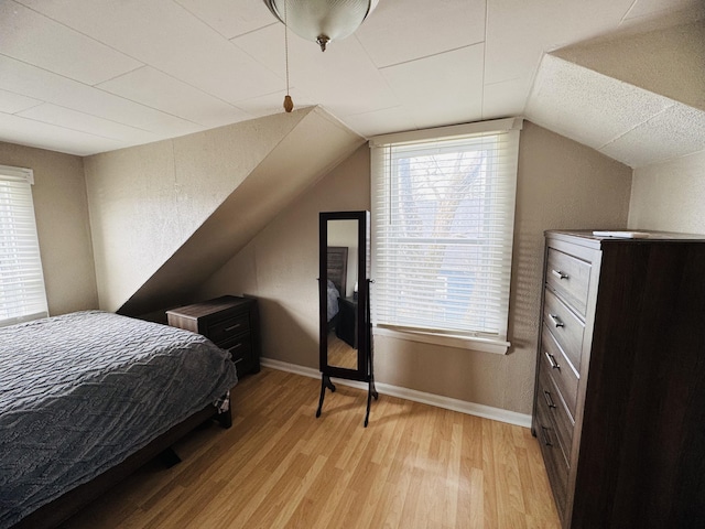 26 Hammond St, Caribou, ME 04736 - bedroom featuring baseboards, lofted ceiling, and light wood-type flooring