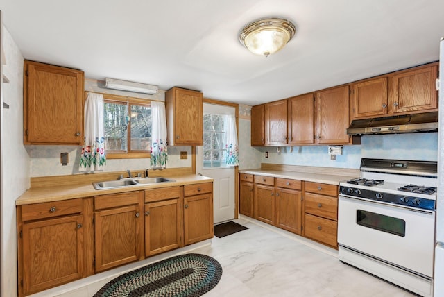89 14th St, Shapleigh, ME 04076 - kitchen featuring white gas range, light countertops, a sink, and under cabinet range hood