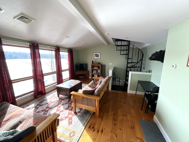 150 Birchwood Rd, Gray, ME 04039 - living area with visible vents, baseboards, lofted ceiling with beams, stairs, and hardwood / wood-style floors