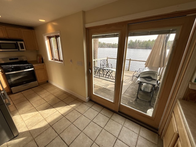 150 Birchwood Rd, Gray, ME 04039 - kitchen featuring baseboards, recessed lighting, a water view, light tile patterned floors, and stainless steel appliances