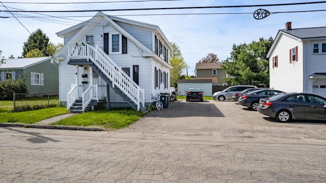 view of asphalt road featuring stairway