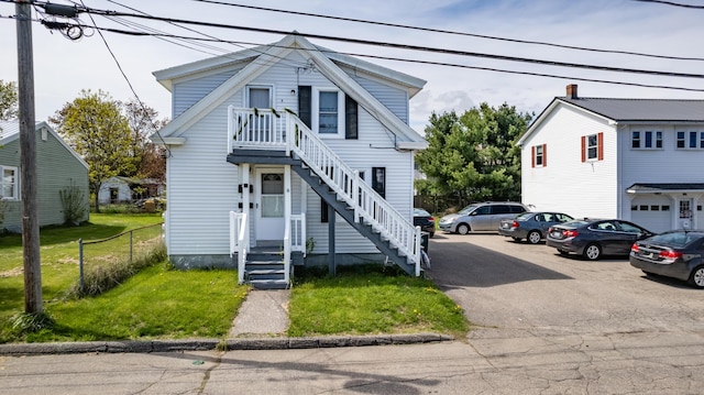 view of front of property with a front lawn and stairs