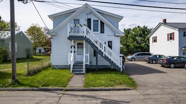 view of front of house featuring a front lawn and stairway