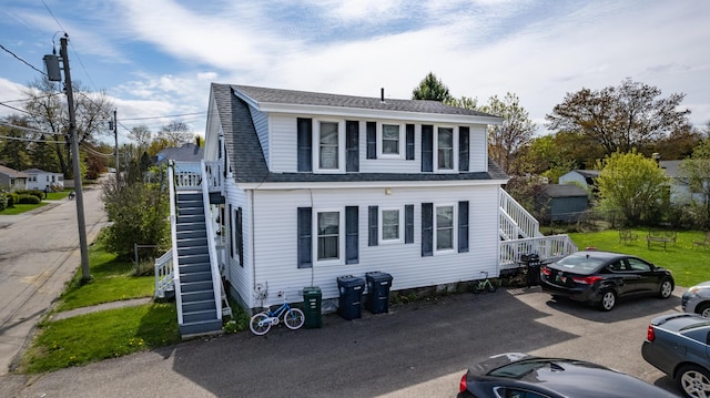 dutch colonial with stairs and roof with shingles