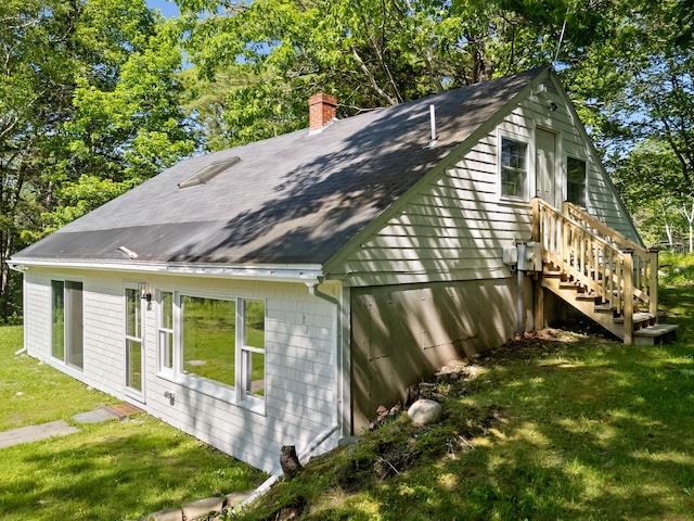 12 Burns Dr, Friendship, ME 04547 - view of side of home with a chimney, a yard, a shingled roof, stairs, and view of wooded area