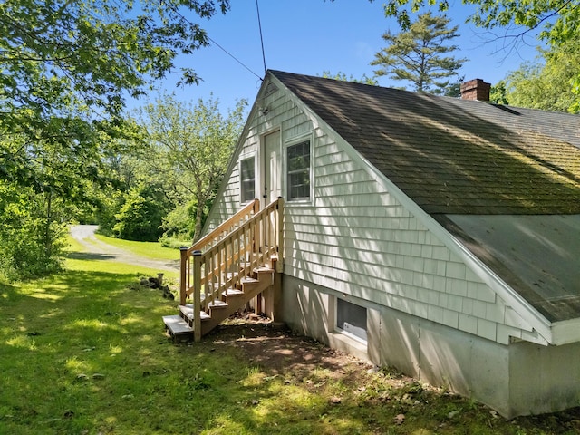 12 Burns Dr, Friendship, ME 04547 - view of side of property featuring roof with shingles, a lawn, and a chimney