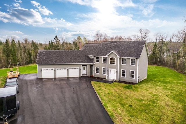 104 Main Trl, Hampden, ME 04444 - colonial house featuring driveway, a garage, a front lawn, and a shingled roof