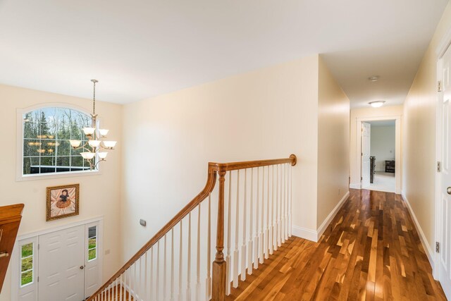 104 Main Trl, Hampden, ME 04444 - hall with a chandelier, wood finished floors, an upstairs landing, and baseboards