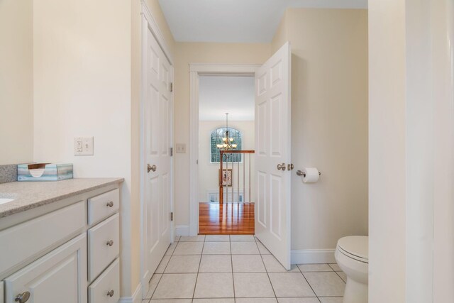 104 Main Trl, Hampden, ME 04444 - bathroom featuring a chandelier, tile patterned floors, baseboards, vanity, and toilet