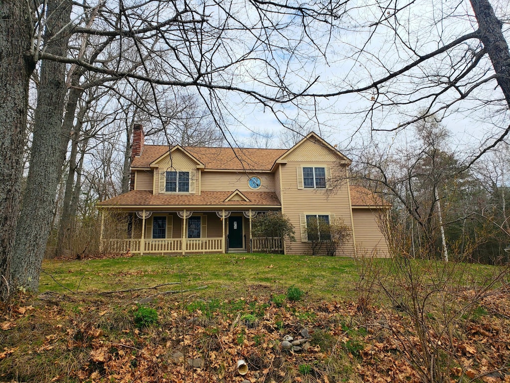 4 Hillside Dr, Veazie, ME 04401 - view of front of home featuring a shingled roof, a chimney, a porch, and a front lawn