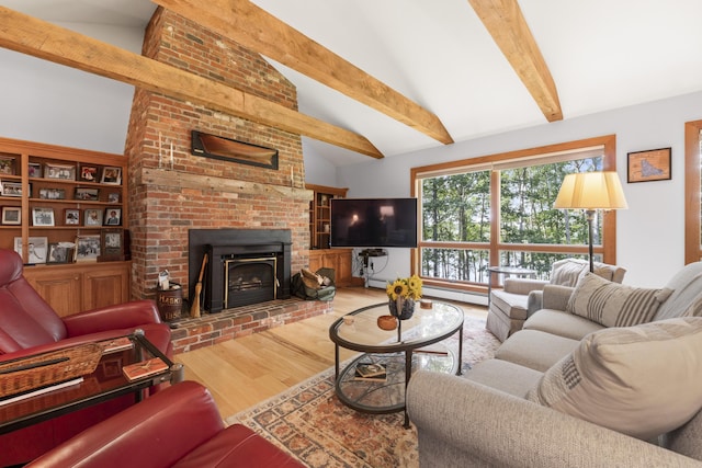 1515 Old Augusta Rd, Waldoboro, ME 04572 - living room with high vaulted ceiling, a brick fireplace, beam ceiling, and wood finished floors