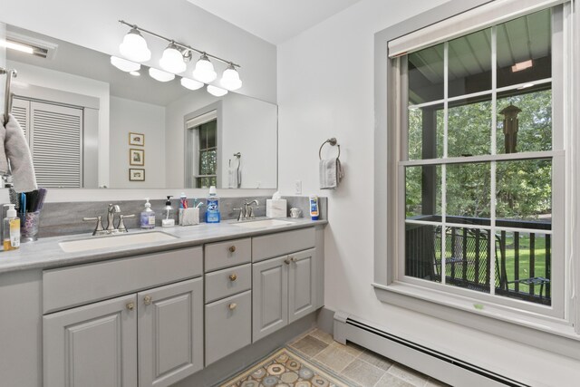 1515 Old Augusta Rd, Waldoboro, ME 04572 - full bath with double vanity, baseboard heating, and a sink