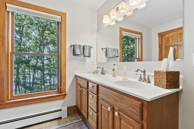 1515 Old Augusta Rd, Waldoboro, ME 04572 - full bath with double vanity, baseboards, a sink, and baseboard heating
