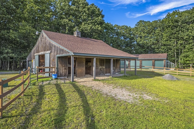 1515 Old Augusta Rd, Waldoboro, ME 04572 - exterior space featuring an exterior structure, an outbuilding, a detached garage, and a chimney