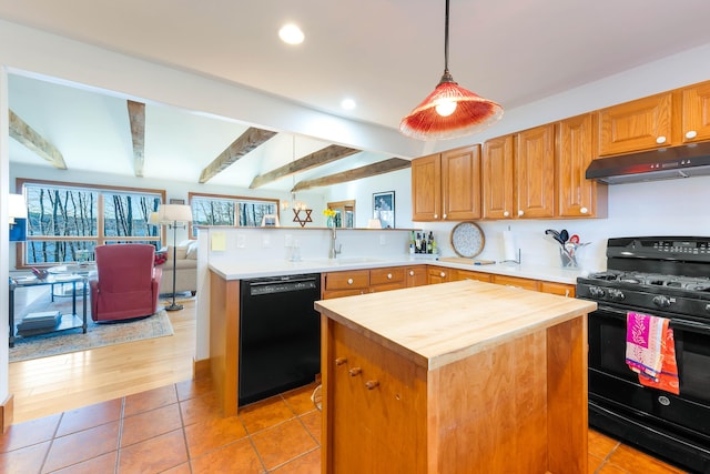 1515 Old Augusta Rd, Waldoboro, ME 04572 - kitchen with a peninsula, butcher block counters, under cabinet range hood, a sink, and black appliances