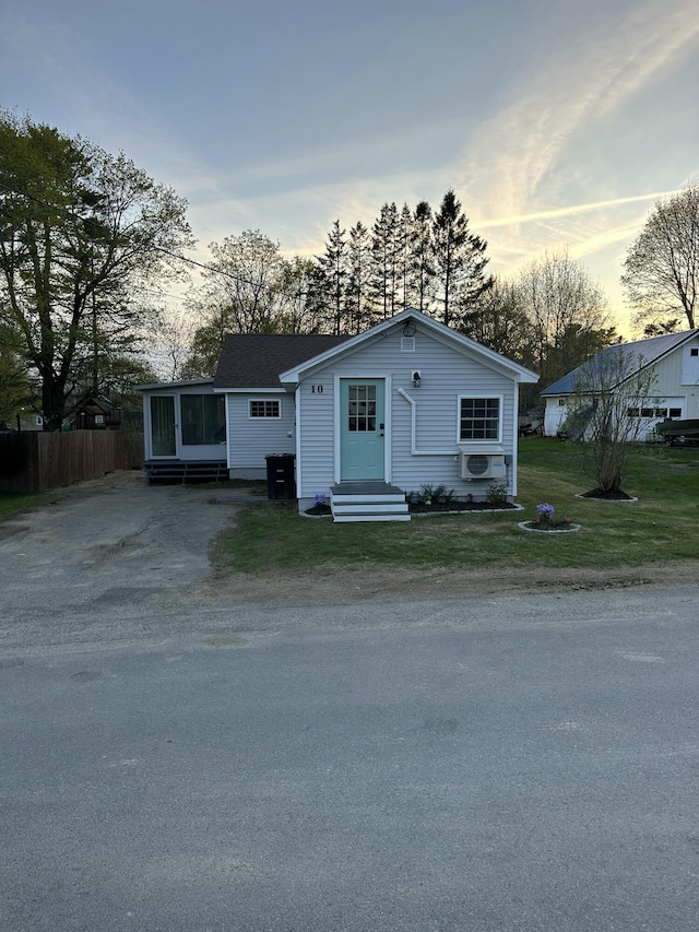 bungalow-style house featuring a yard, entry steps, fence, and driveway