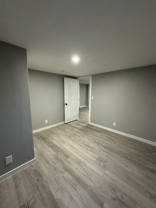 interior space with baseboards and wood finished floors