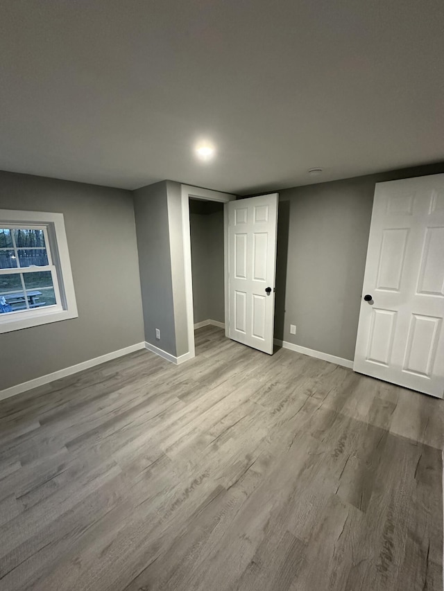 finished basement with wood finished floors and baseboards