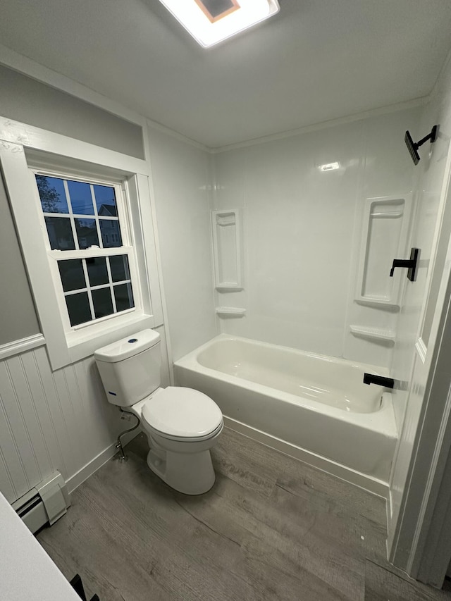 full bathroom featuring toilet, wood finished floors, baseboard heating, and shower / washtub combination