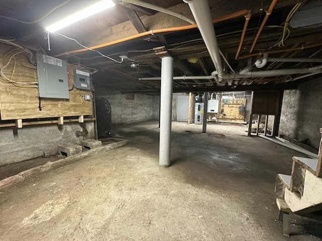 unfinished below grade area with electric panel and water heater