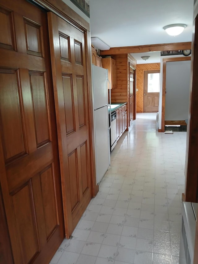 hallway with light floors and wood walls