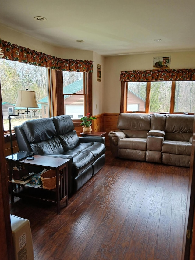 living room with wood walls, wainscoting, recessed lighting, and hardwood / wood-style flooring