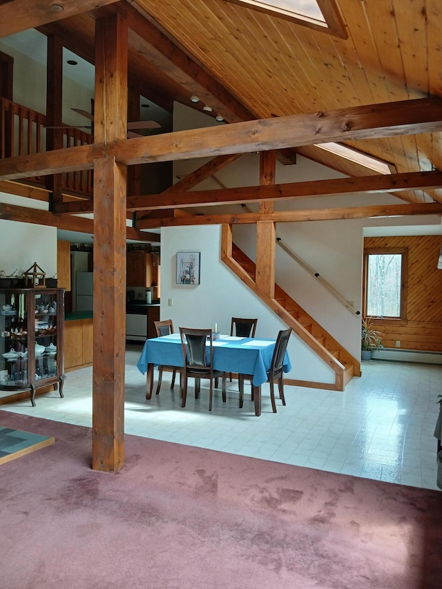 carpeted dining room featuring a baseboard heating unit, stairway, and lofted ceiling with beams