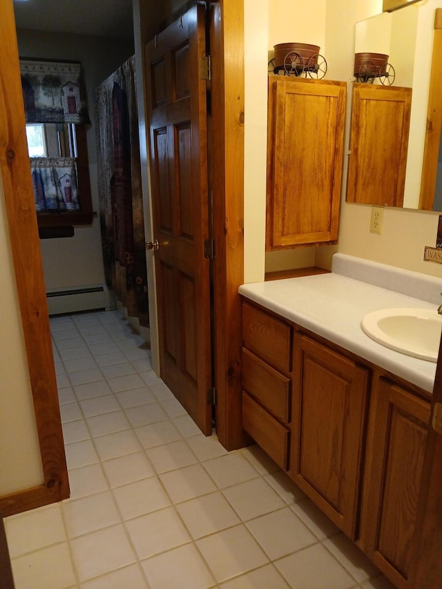bathroom featuring a shower with curtain, tile patterned flooring, baseboard heating, and vanity