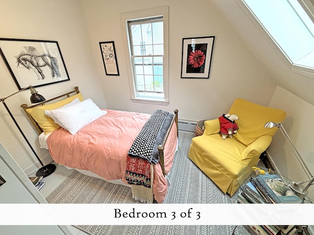 bedroom featuring lofted ceiling and a baseboard radiator