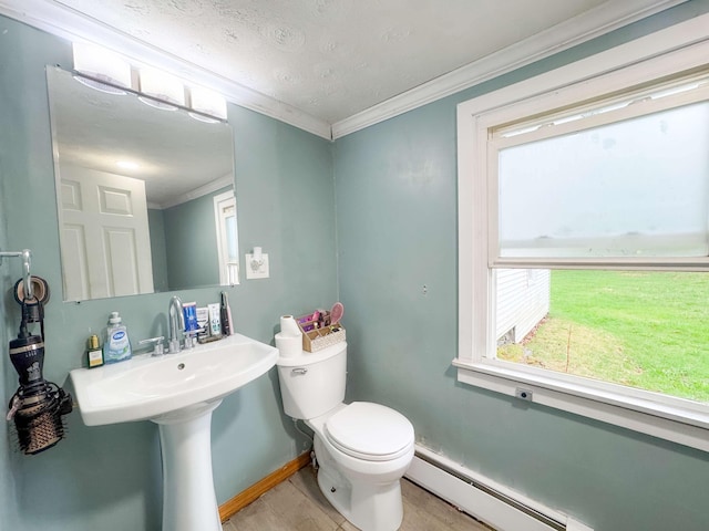 half bathroom featuring baseboard heating, toilet, baseboards, wood finished floors, and ornamental molding