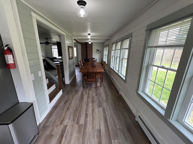 6 Gully Brook Ln, Orland, ME 04472 - dining room featuring a baseboard heating unit, dark wood finished floors, plenty of natural light, and wood walls