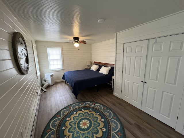 6 Gully Brook Ln, Orland, ME 04472 - bedroom with wooden walls, dark wood-type flooring, a ceiling fan, and a closet