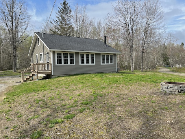 6 Gully Brook Ln, Orland, ME 04472 - view of side of property with a fire pit, a lawn, and roof with shingles