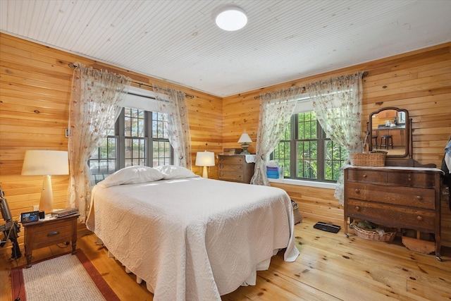 32 Whites Pond Rd, Palmyra, ME 04965 - bedroom with wood walls, multiple windows, and wood-type flooring