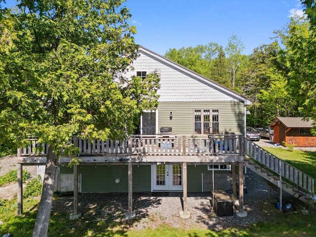 32 Whites Pond Rd, Palmyra, ME 04965 - back of property with a wooden deck, french doors, and stairway